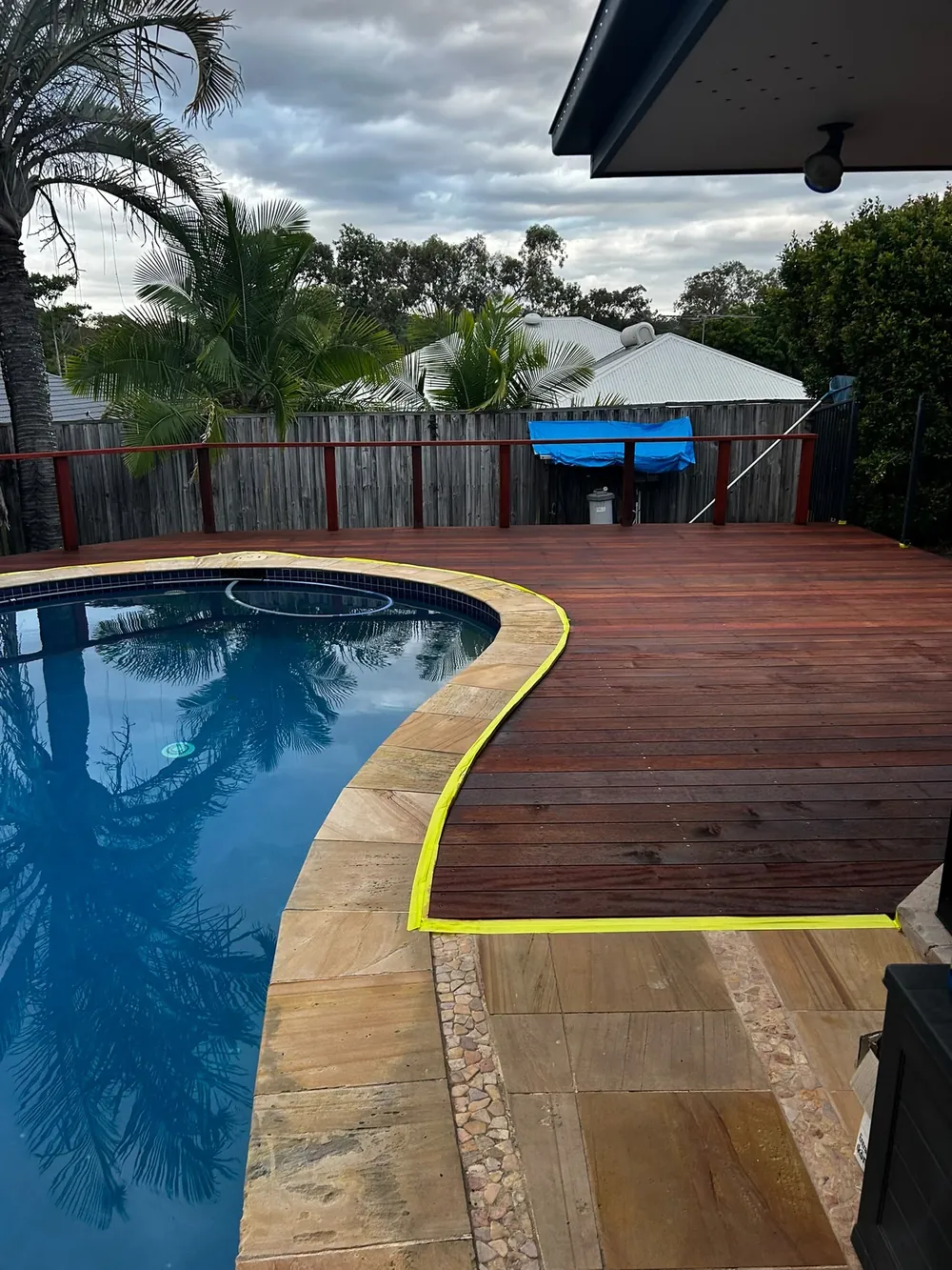 After: finished merbau deck around a kidney-shaped pool