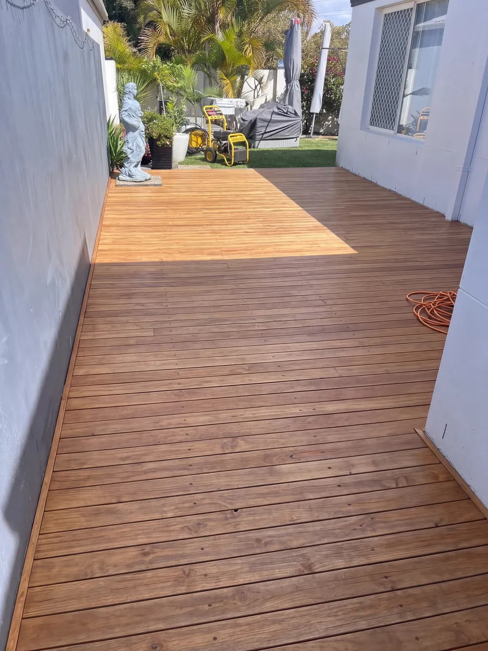 After (illustration): side-path deck stripped back to natural hardwood and oiled