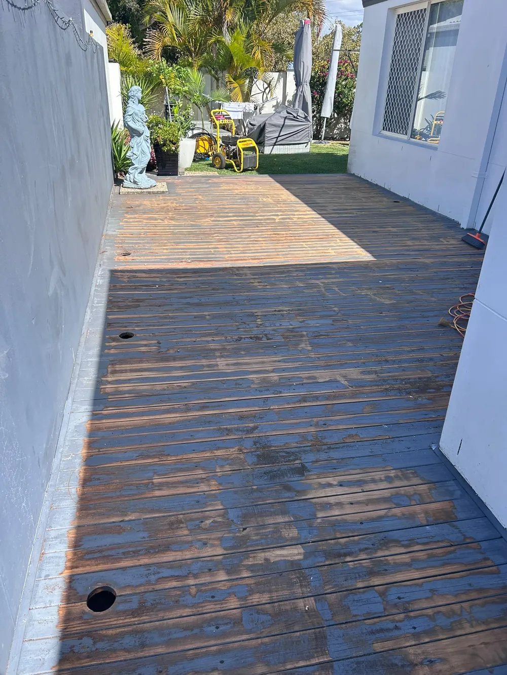 Before: weathered, stained side-path deck boards